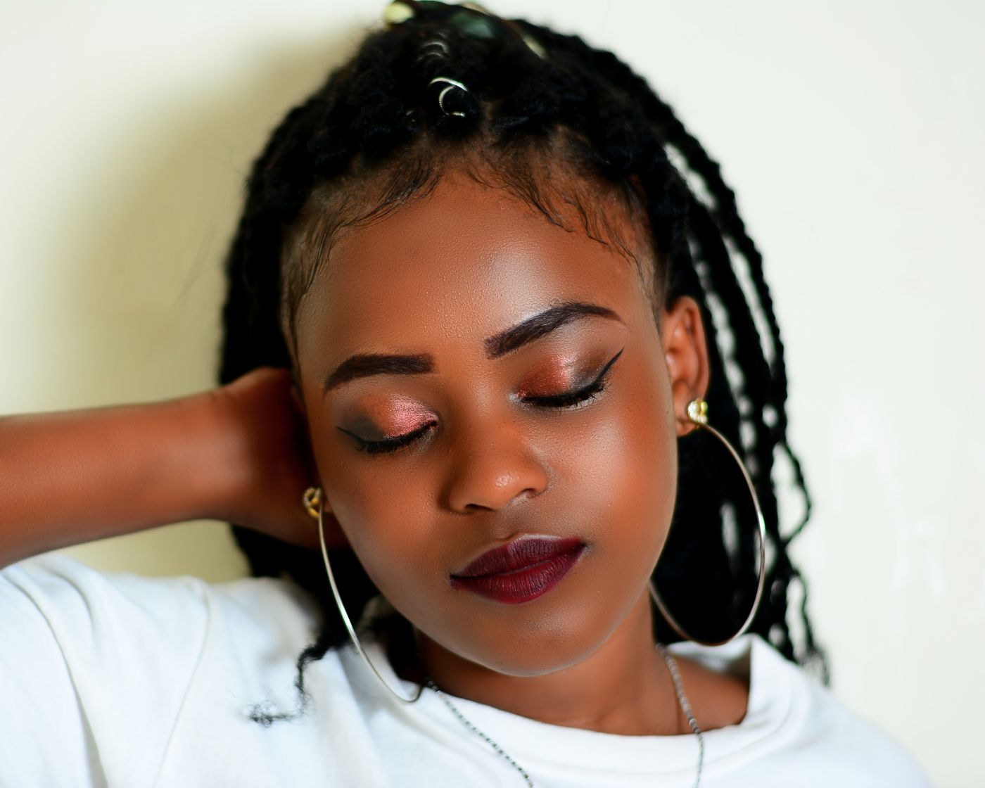 Client wearing neatly finished long braids